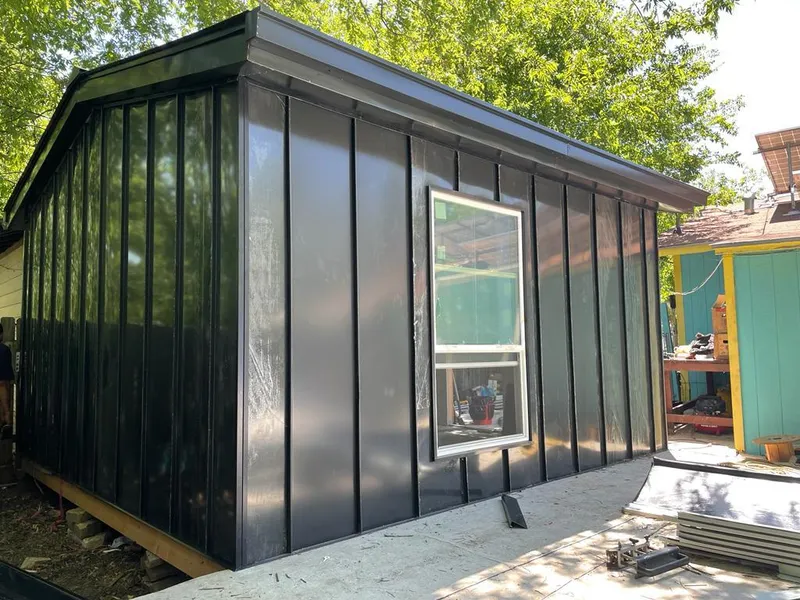 Black standing seam metal wall panels for Roof Inspection in Taos